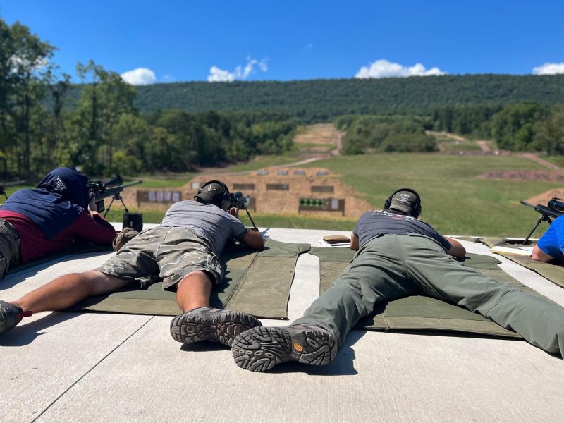 student behind spotting scope during long range precision rifle training