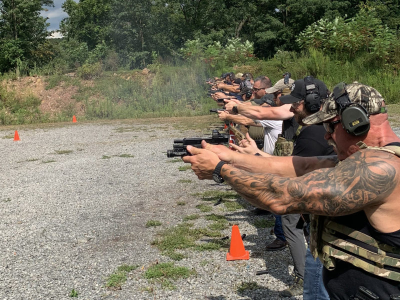 private group practicing defensive handgun drills on range