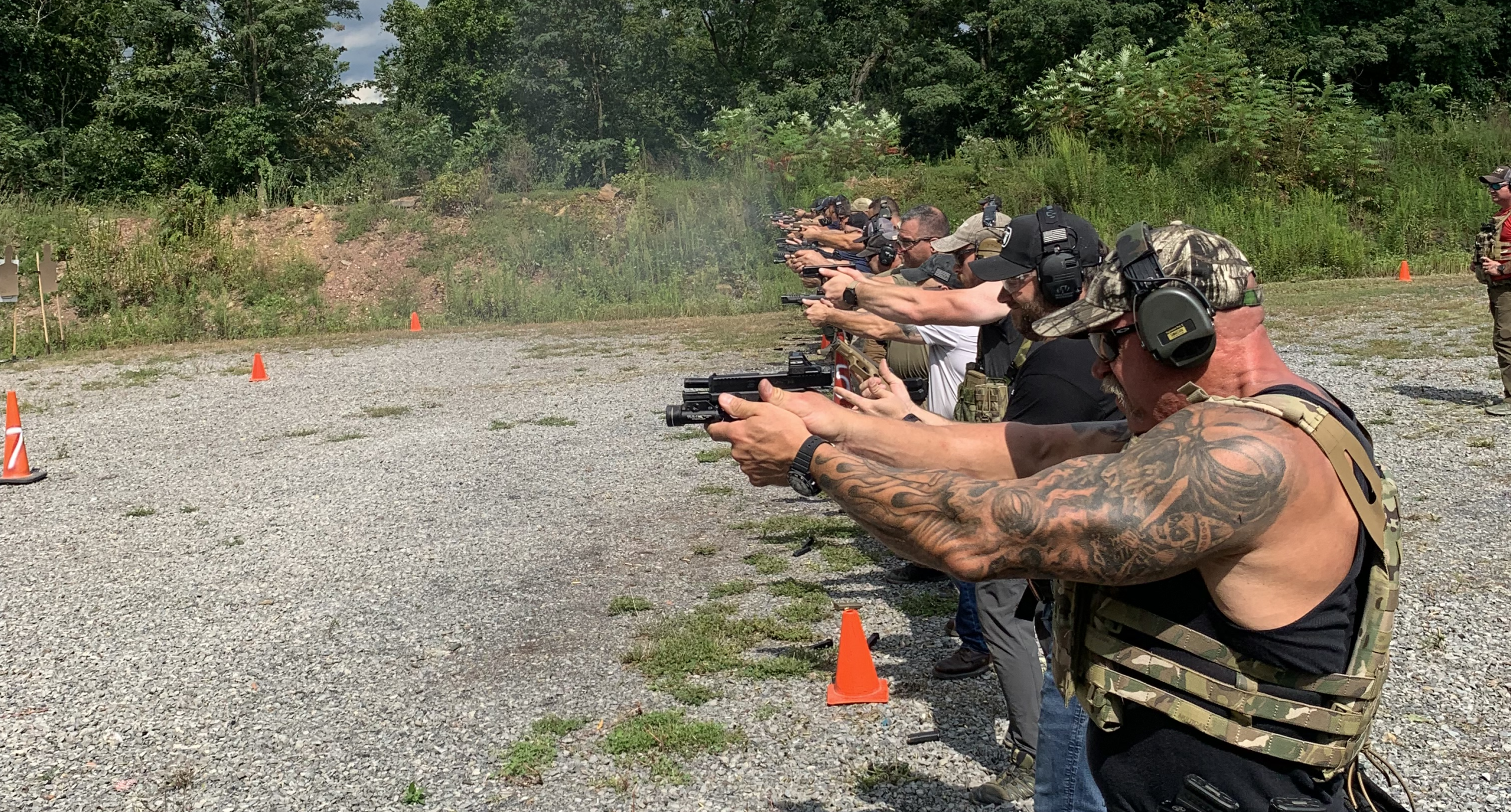private group practicing defensive handgun drills on range
